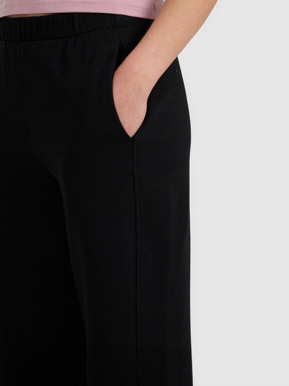 Damskie spodnie dresowe z szerokimi nogawkami 4F 4FRAW25TTROF1614 - czarne