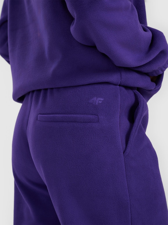 Damskie spodnie dresowe joggery polarowe 4F 4FRAW25TTROF1707 - fioletowe