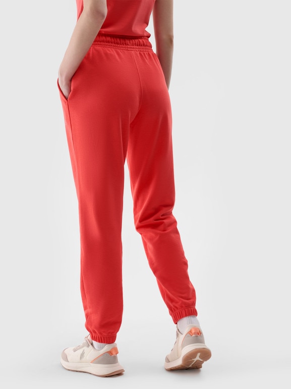 Damskie spodnie dresowe joggery 4F 4FWMM00TTROF1138 - czerwone