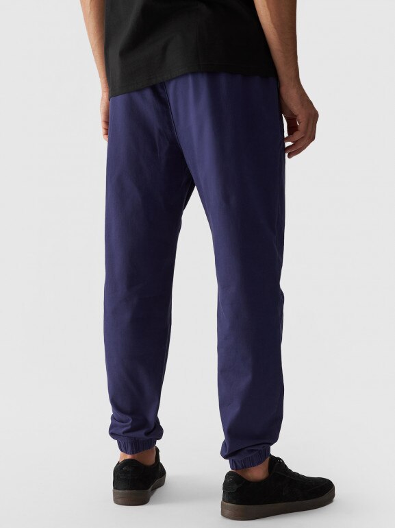 Męskie spodnie casual joggery 4F 4FWMM00TTROM0944 - granatowy