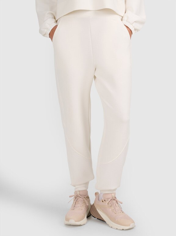 Damskie spodnie dresowe joggery 4F 4FWAW25TTROF1180 - białe
